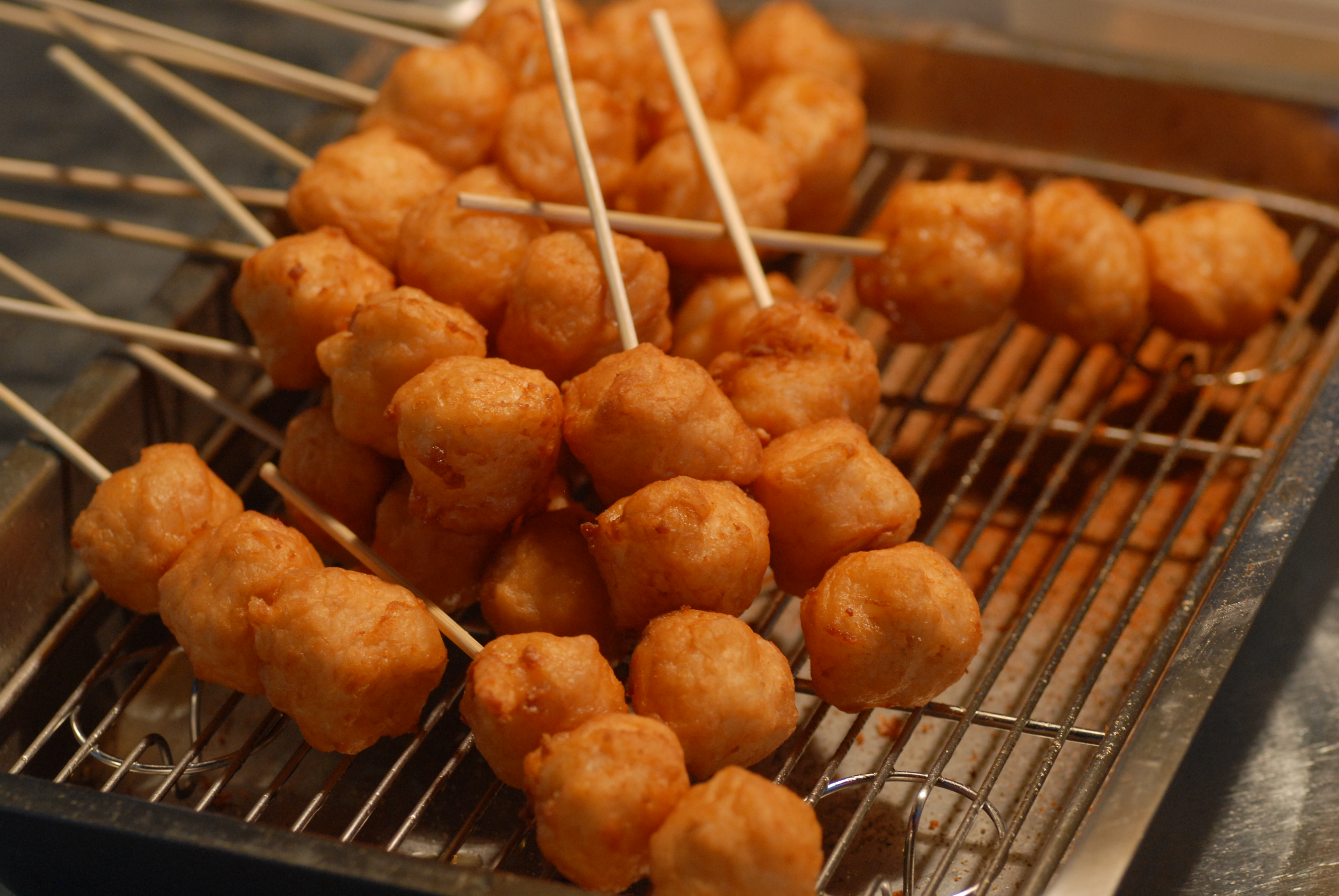 Night market food stalls with evening crowd energy at a summer market.