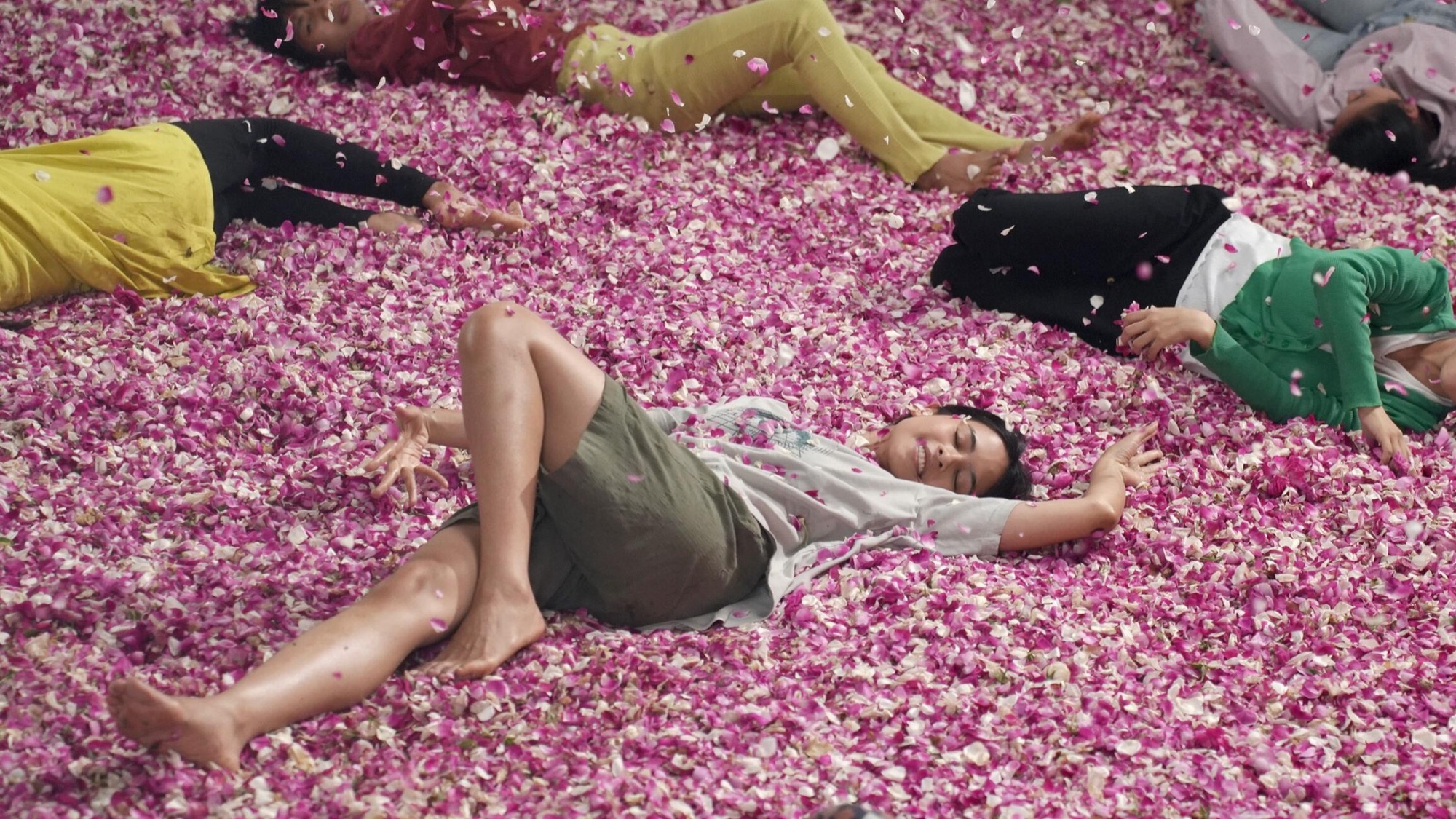 Young women lie among pink rose petals in a trance sequence from Wregas Bhanuteja's Levitating, the AAIFF49 opening-night film.