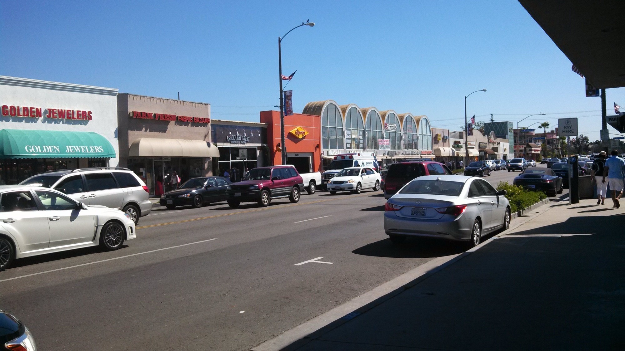 Storefronts and traffic on Pioneer Boulevard in Artesia’s Little India corridor.