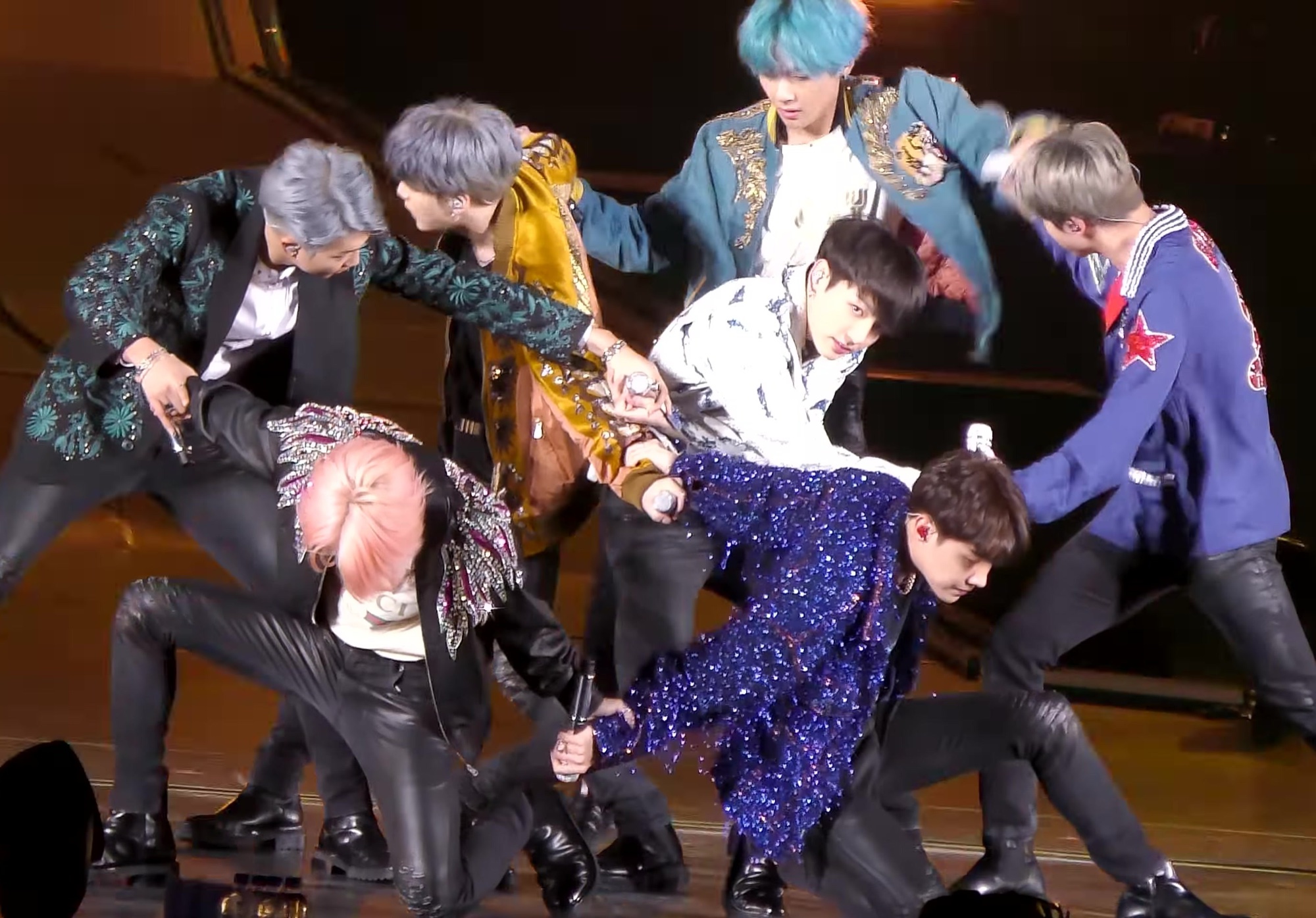 BTS performing DNA in a tight formation on stage during the Love Yourself concert in Nagoya on January 13, 2019.