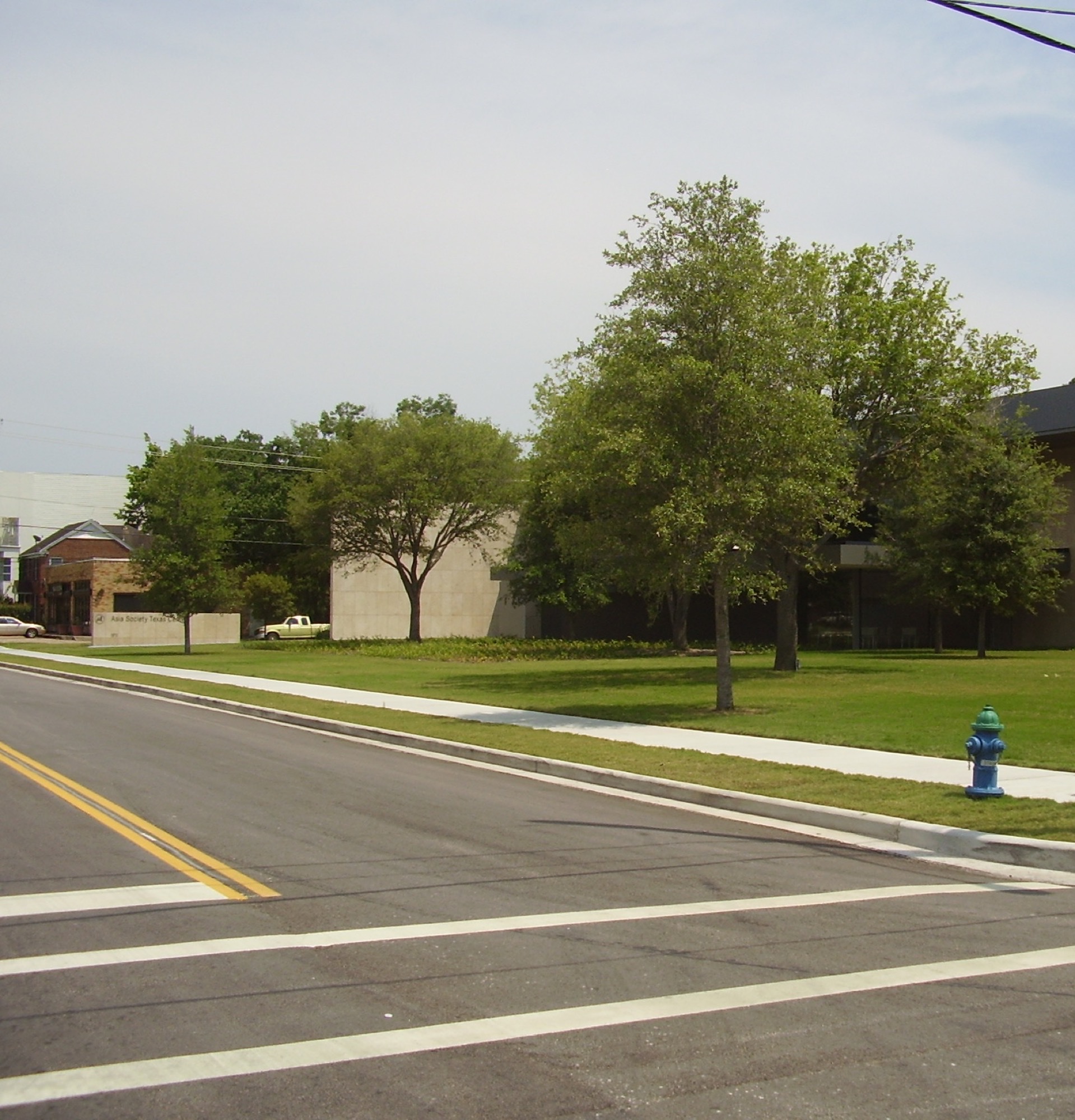 Exterior of Asia Society Texas Center in Houston with lawn and street frontage.
