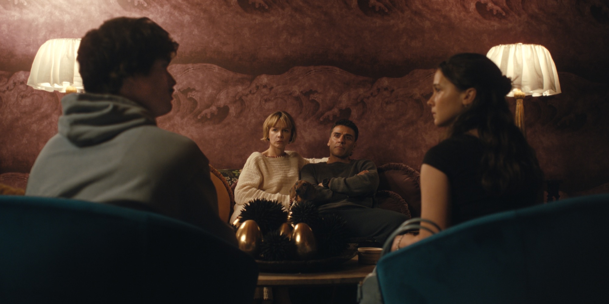 Oscar Isaac and Carey Mulligan seated on a couch facing Charles Melton and Cailee Spaeny across a coffee table in Beef Season 2.