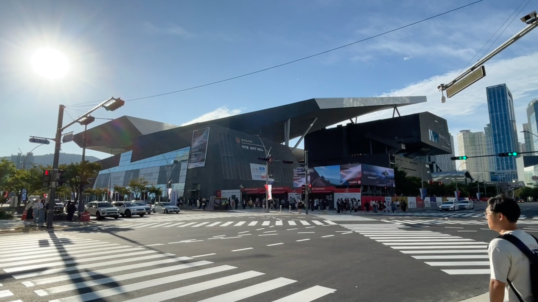 Busan Cinema Center and BIFF Hill across a Centum City crosswalk, festival banners on the facade.