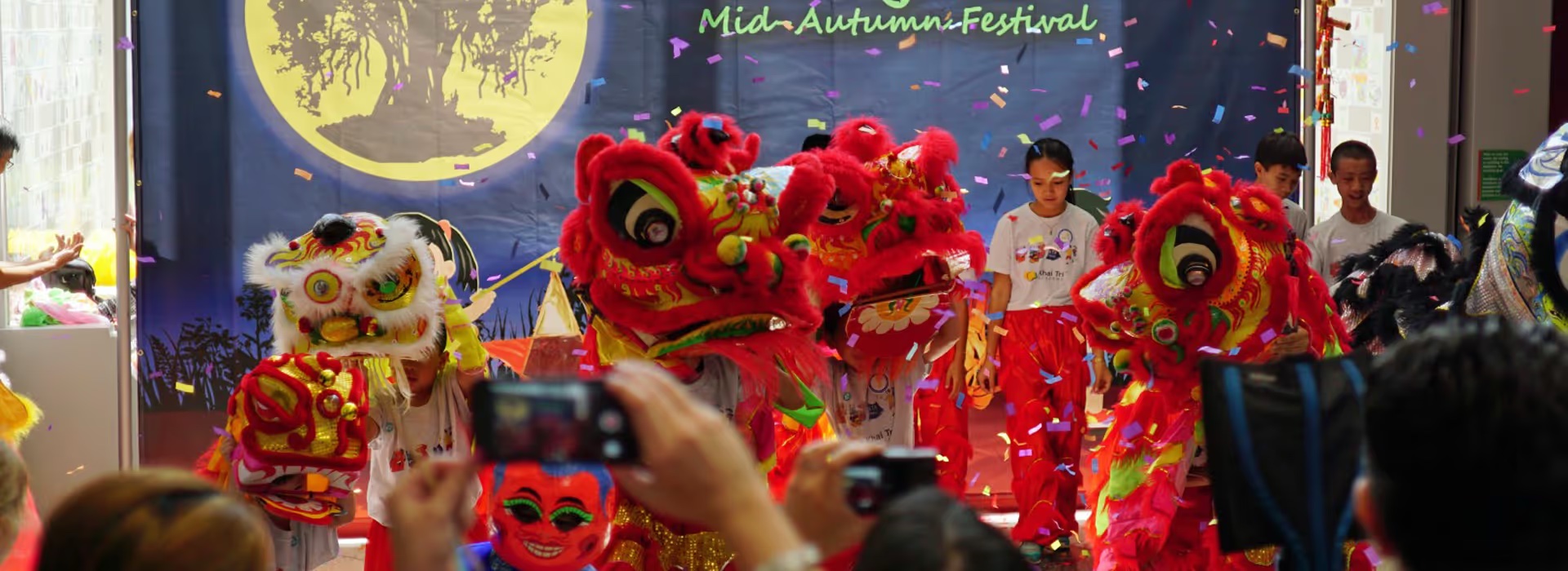 Lion dancers perform under Mid-Autumn Festival banners at Children's Museum Houston.