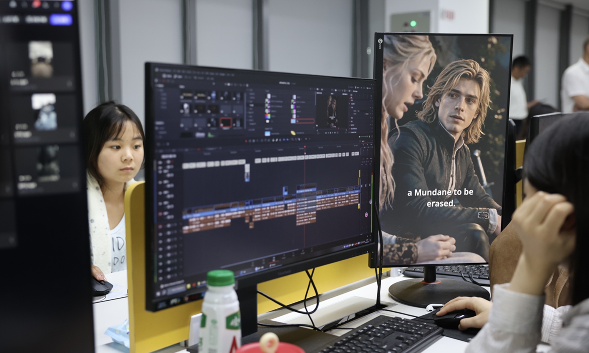 Editors at a Chinese microdrama company work multi-monitor stations, with a vertical screen showing English-subtitled Western fantasy characters during AI-assisted post-production.