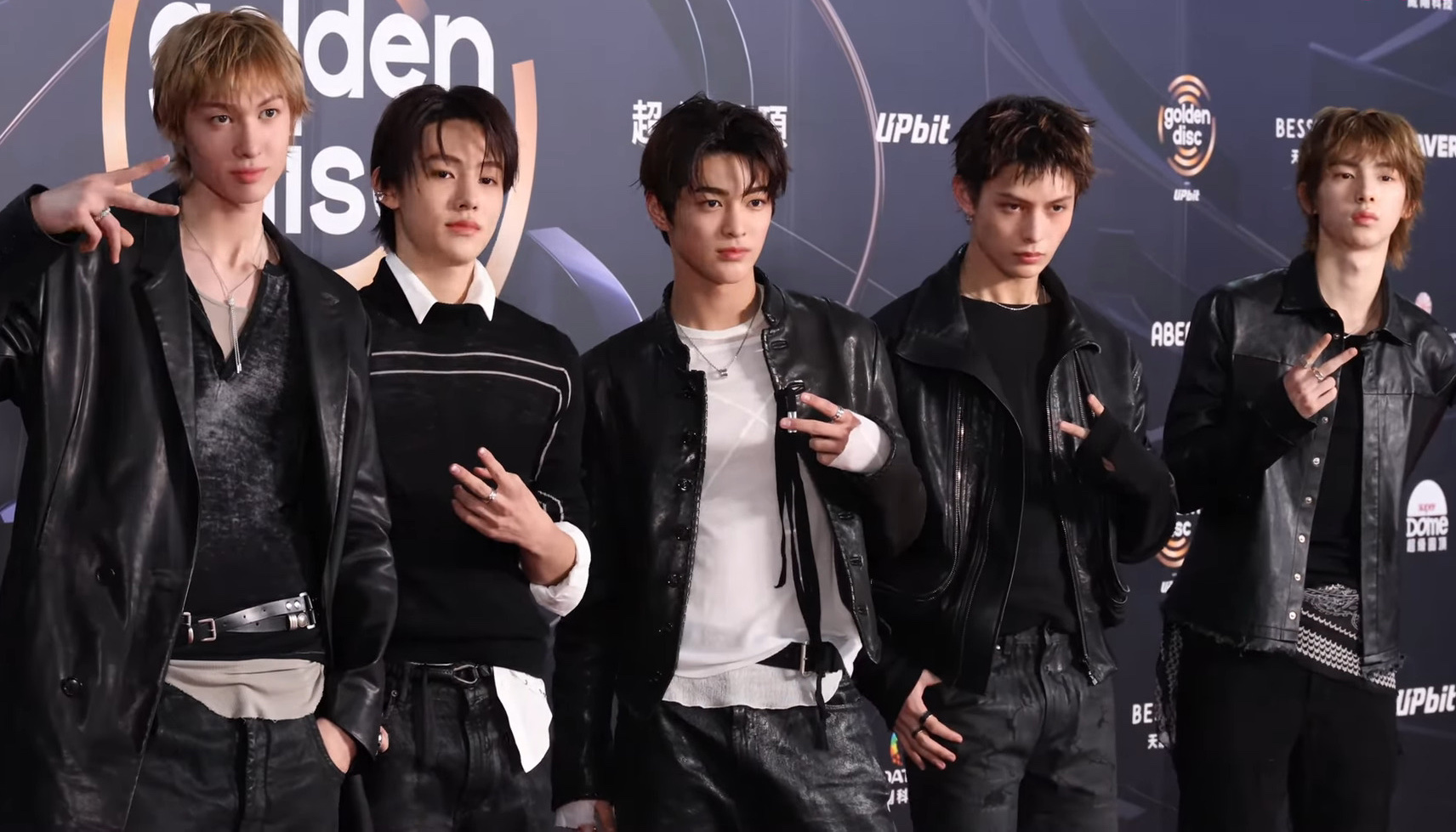 Five-member boy group Cortis poses on the Golden Disc Awards red carpet in coordinated dark and metallic stage looks.