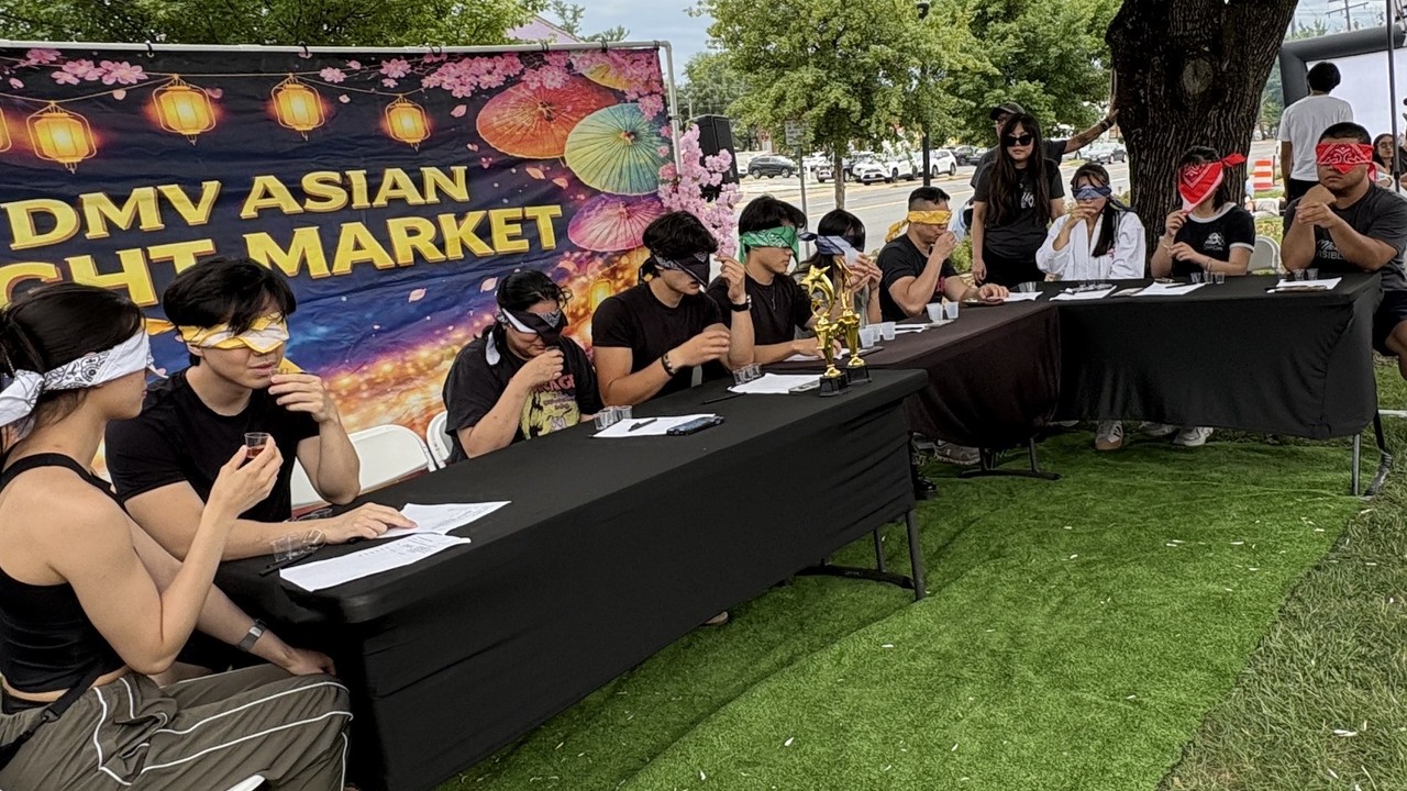 Food vendors and crowds at the DMV Asian Night Market on Columbia Pike in Annandale, Virginia.