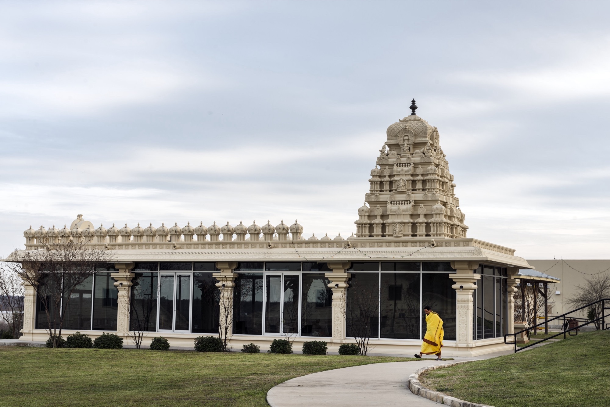 Exterior of Austin Hindu Temple on Decker Lake Road with tower and lawn.