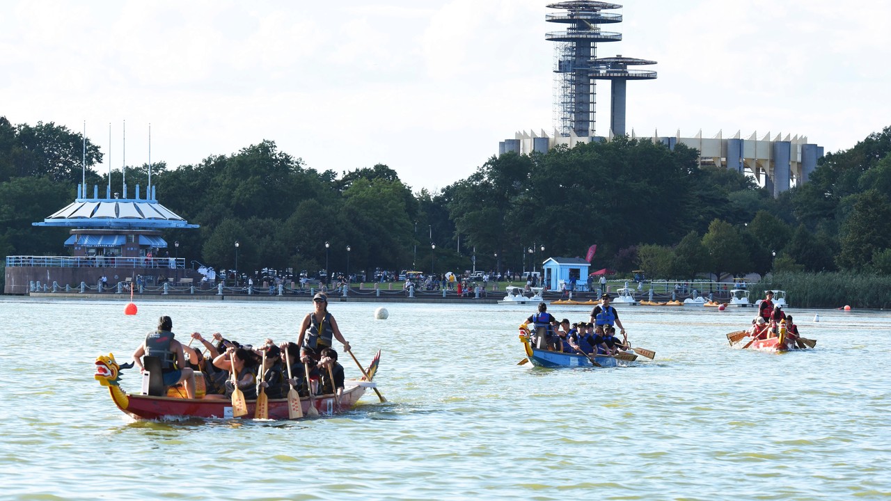 Dragon boat teams racing at Meadow Lake in Flushing Meadows Corona Park.