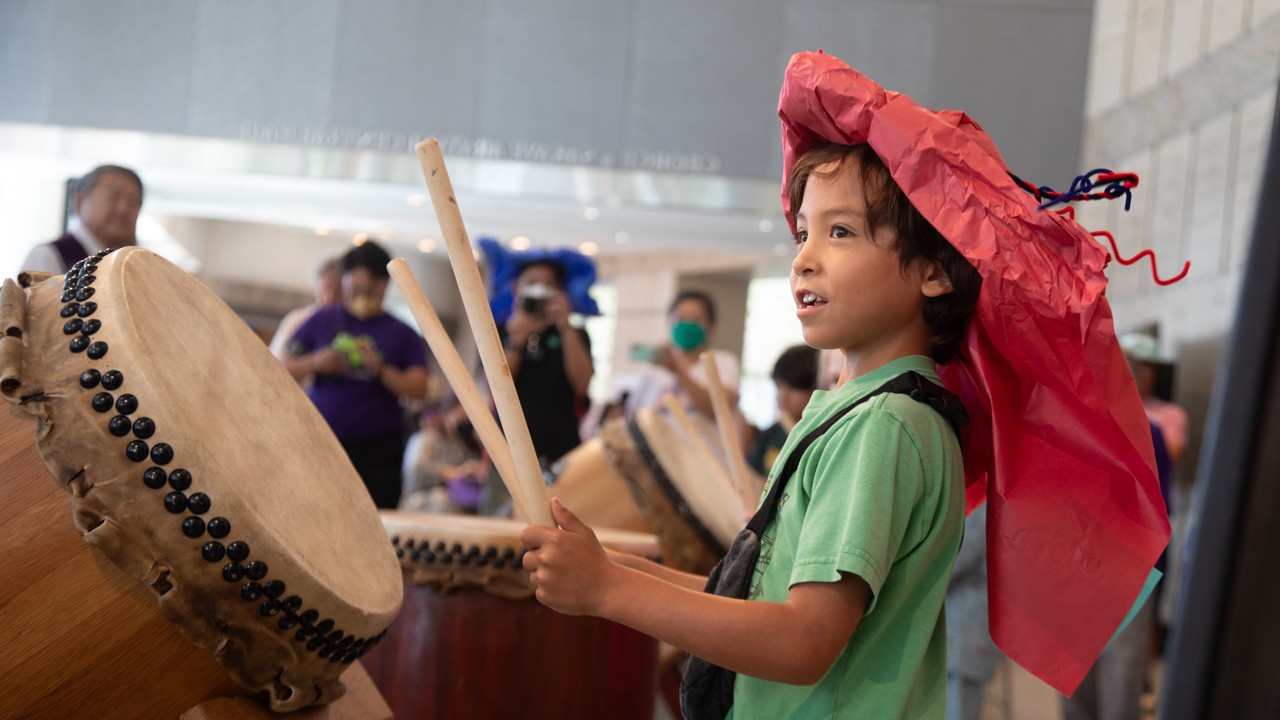 Child in taiko drum hat at JANM Natsumatsuri Family Festival in Little Tokyo.