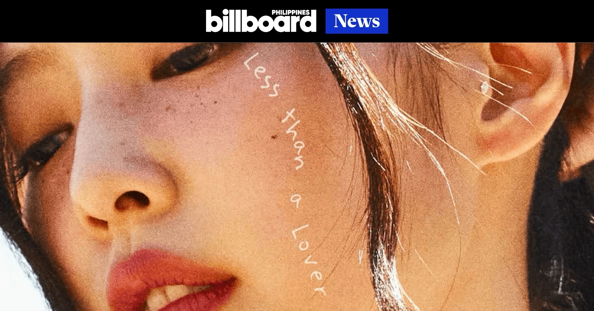 Jennie in a white dress sitting in a blue pickup truck under open sky in the Less than a Lover music video.