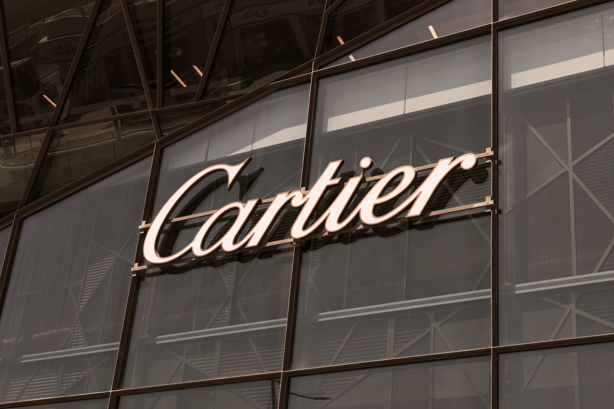 Illuminated Cartier storefront logo, one of the houses winning red carpet jewelry moments.