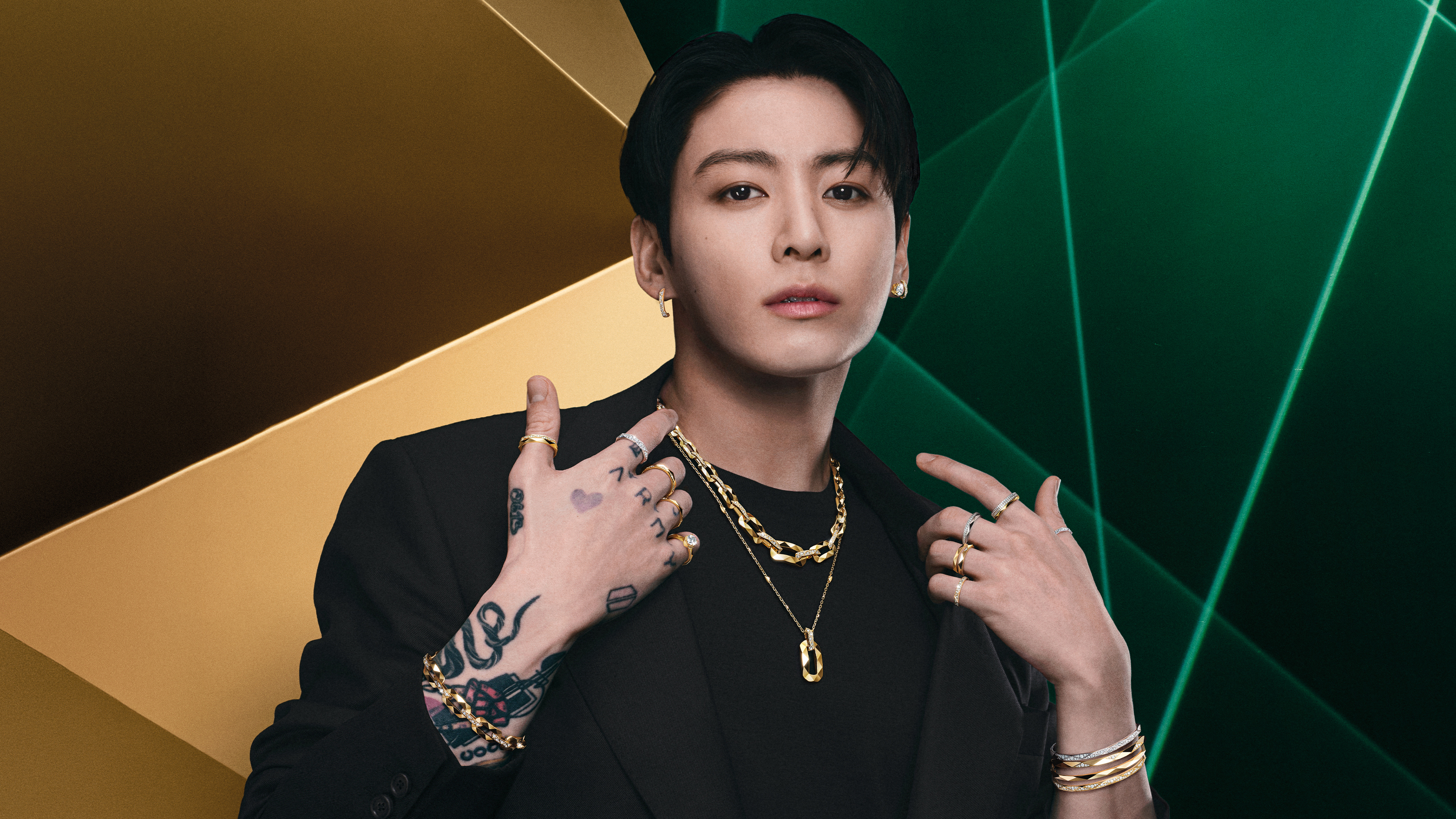Jung Kook wearing layered Laurence Graff Signature jewelry in Graff's green and gold 2026 campaign.