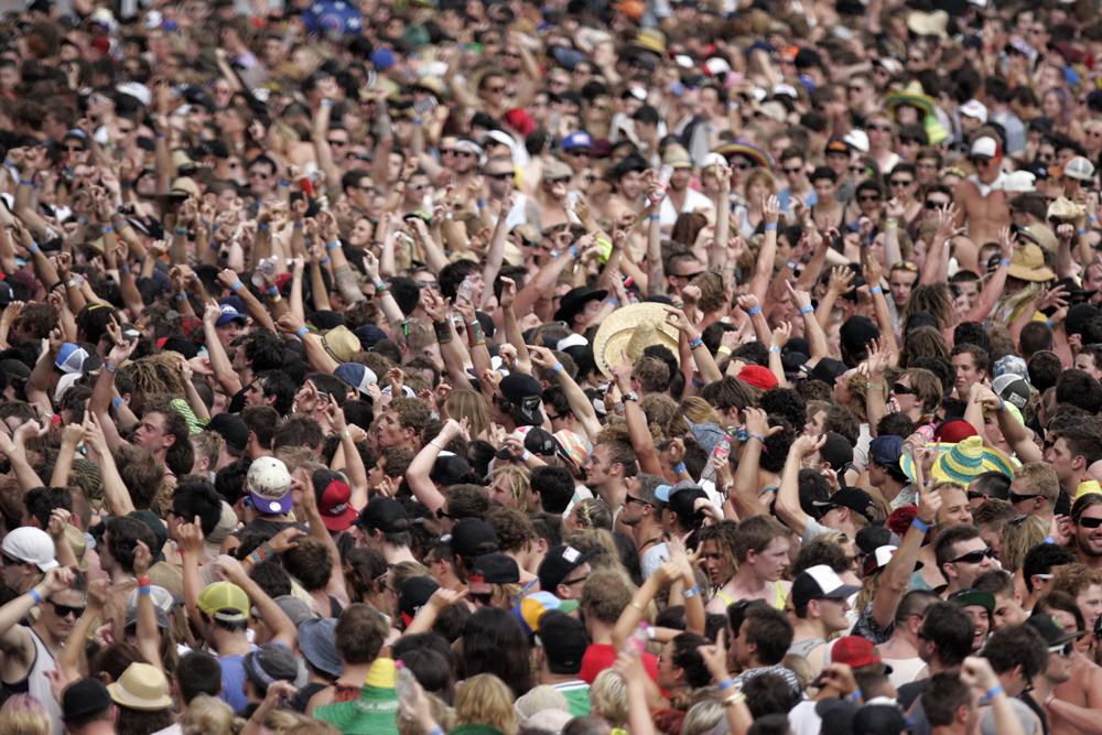 Outdoor music festival crowd at a large concert.
