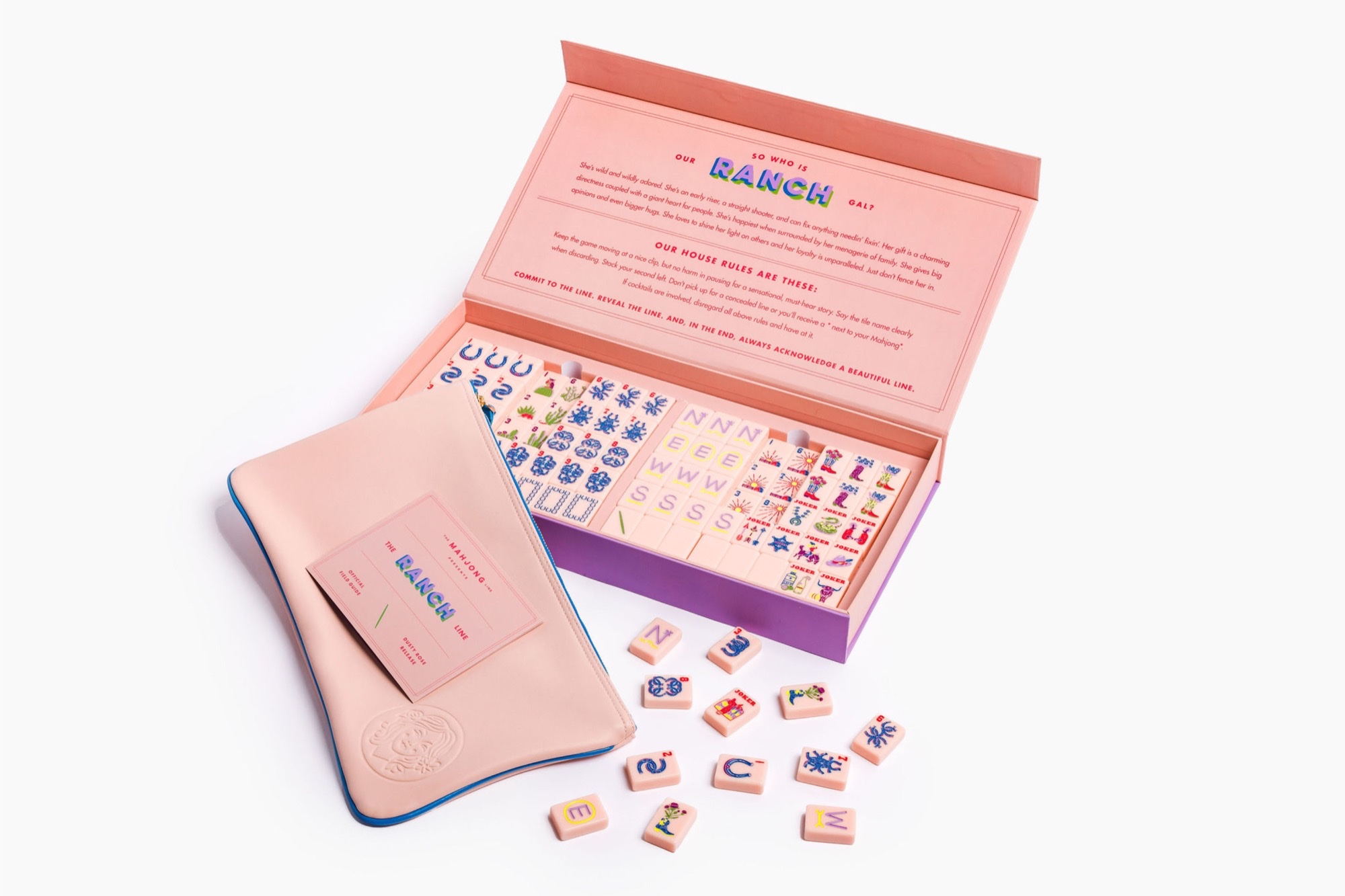 The Mahjong Line Ranch Line dusty rose American mahjong set open in its pink and purple box, with tile bag, field guide, and Texas-themed tiles.