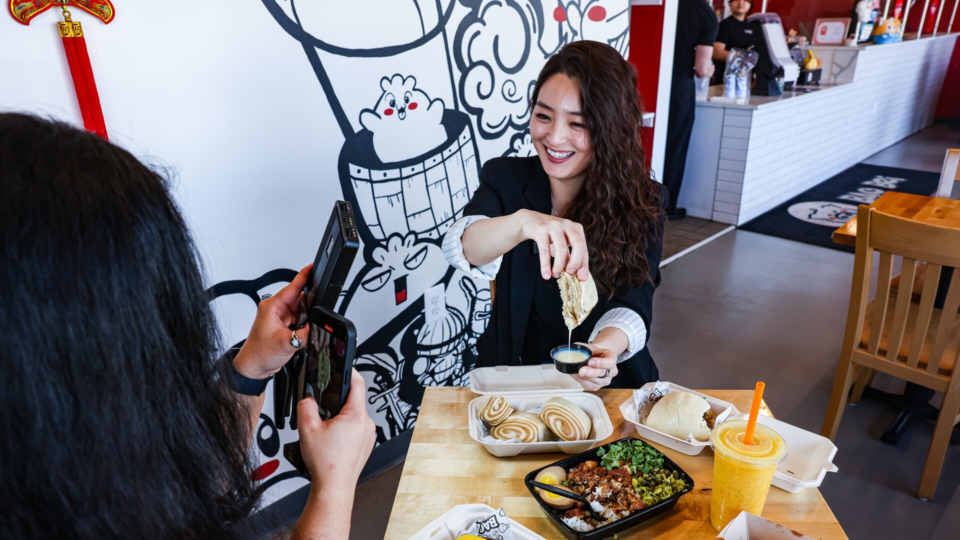 Kimberly Kong filming a Maryland Asian restaurant stop for her Nomtastic Kim series.