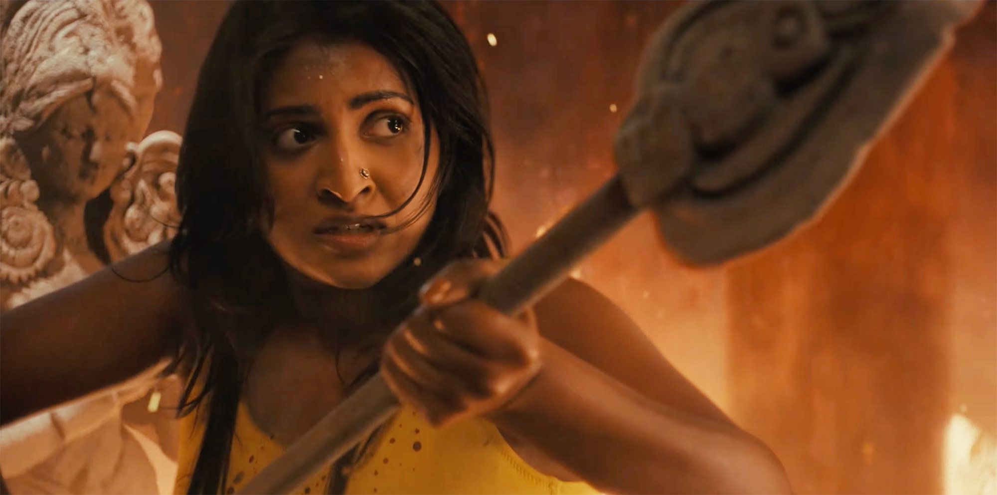 Kirunthuja Srikanth-Talim as Gayatri gripping a staff in a firelit temple setting from Junghal Studios’ Namaslay.