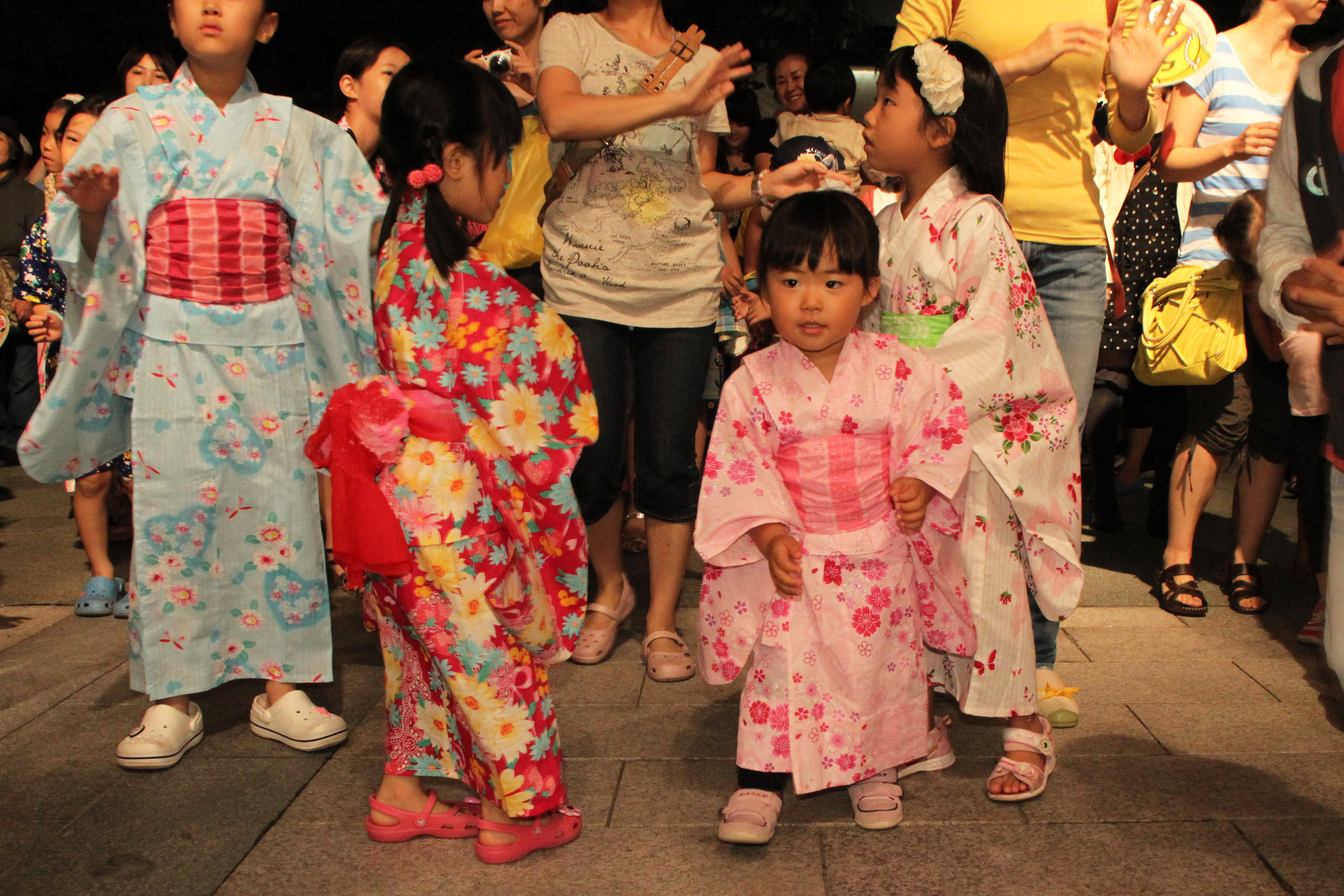 Participants enjoying Bon Odori dancing at a summer temple festival.