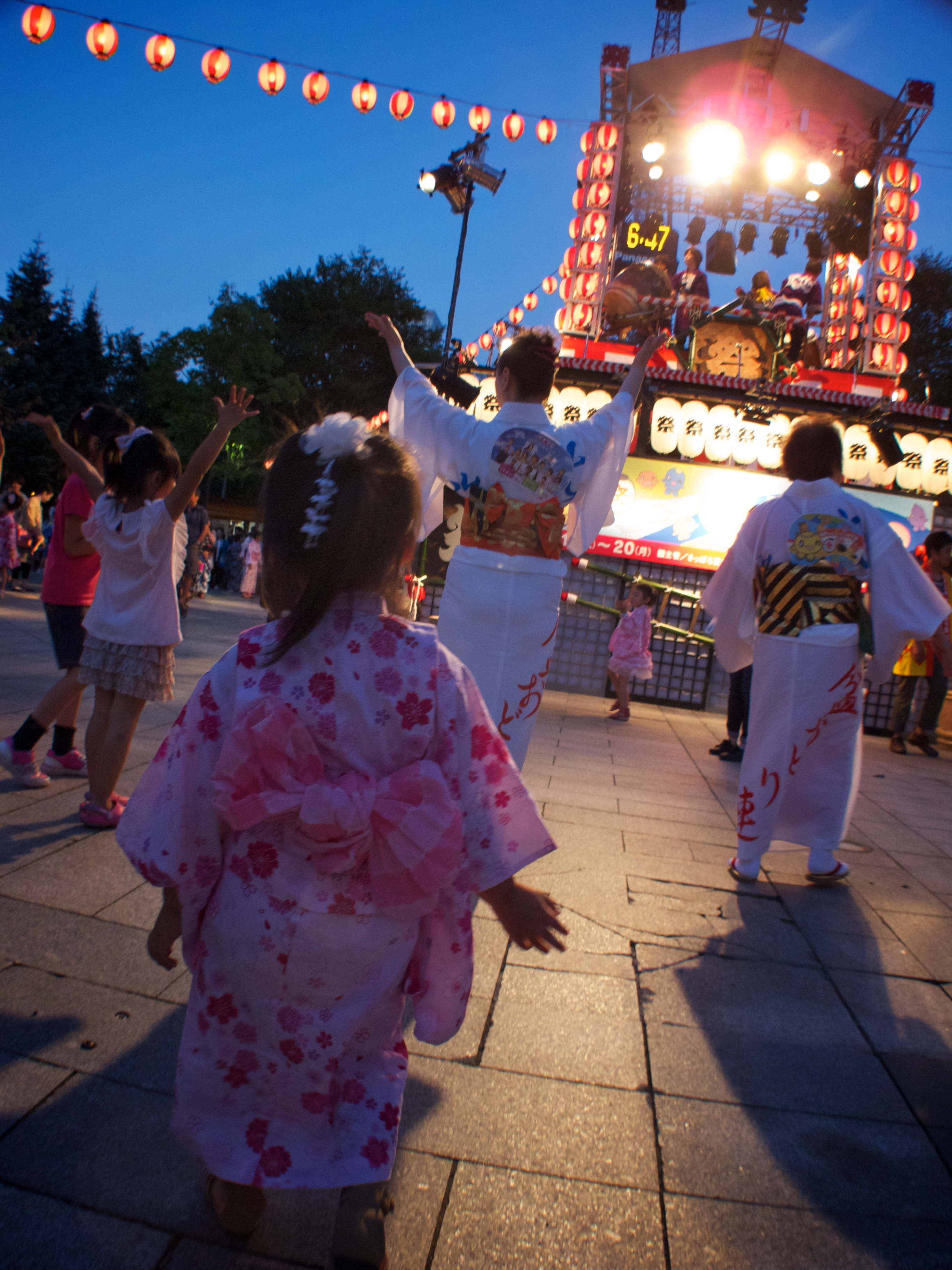 Bon Odori dancers joining a summer temple festival dance.