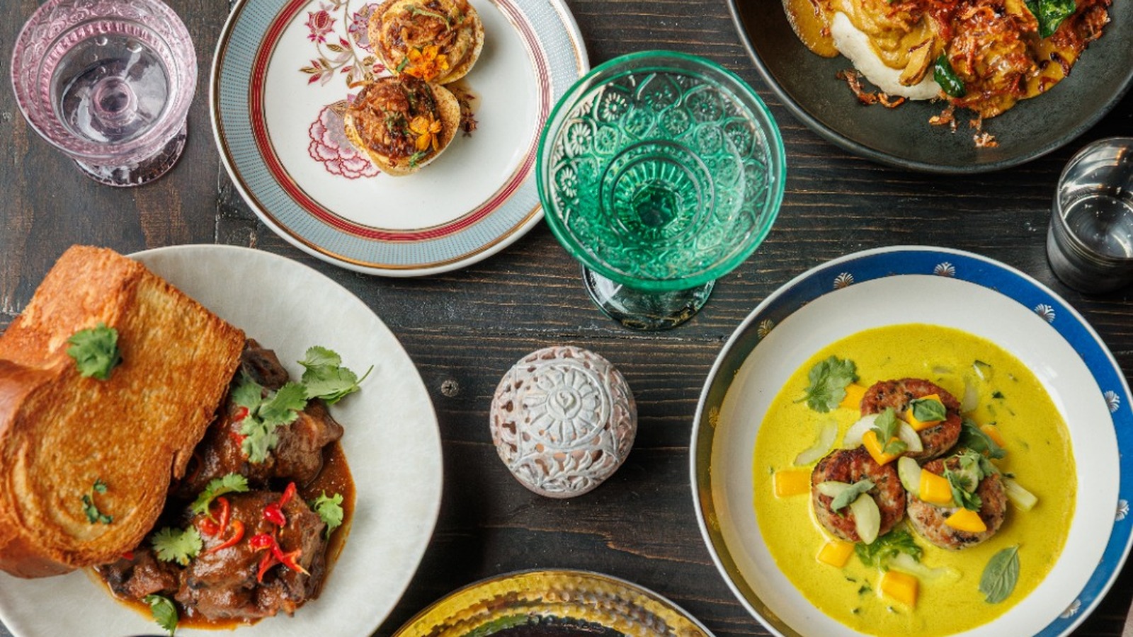 A colorful overhead spread of dishes served at chef Aarthi Sampath's Drāvida restaurant in New York.
