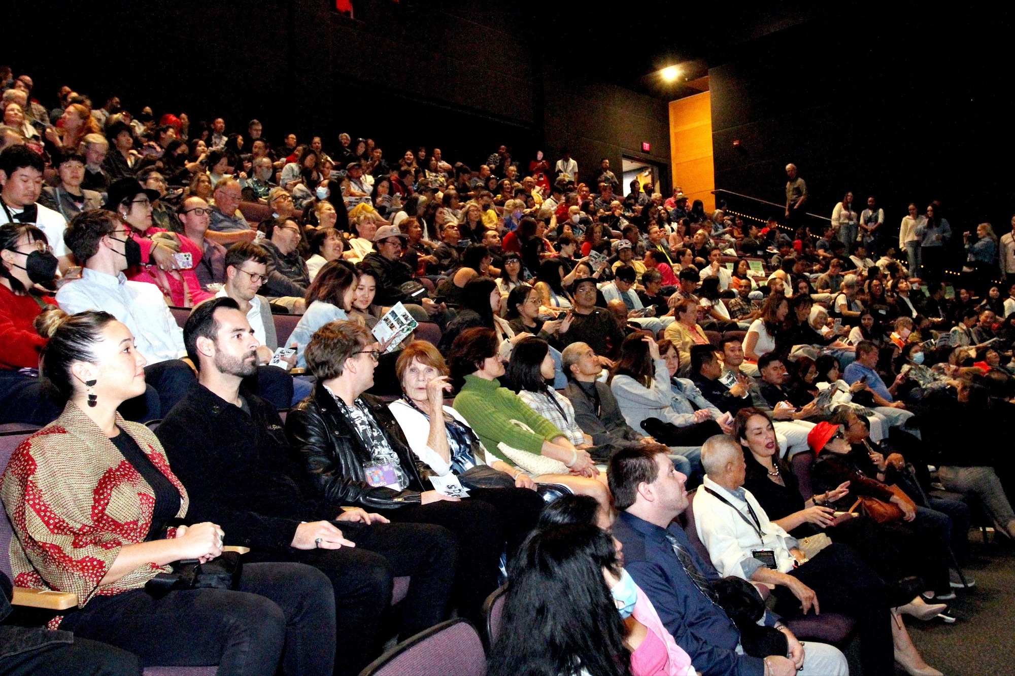 Audience seated in a cinema for a San Diego Asian Film Festival screening.