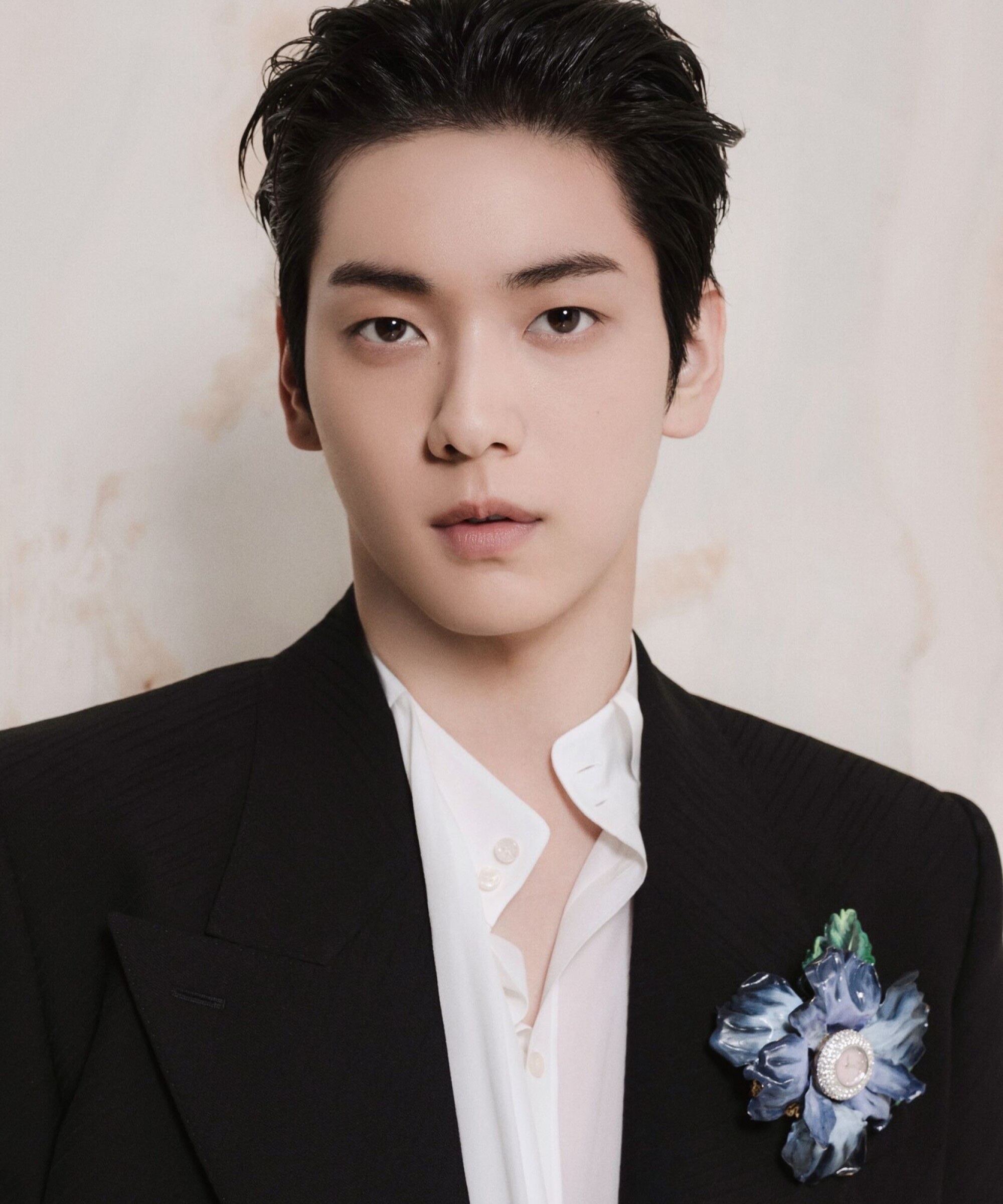 TXT's Soobin in a black Dolce&Gabbana blazer and white shirt with a blue flower brooch for the Fall/Winter 2026 ambassador portraits.