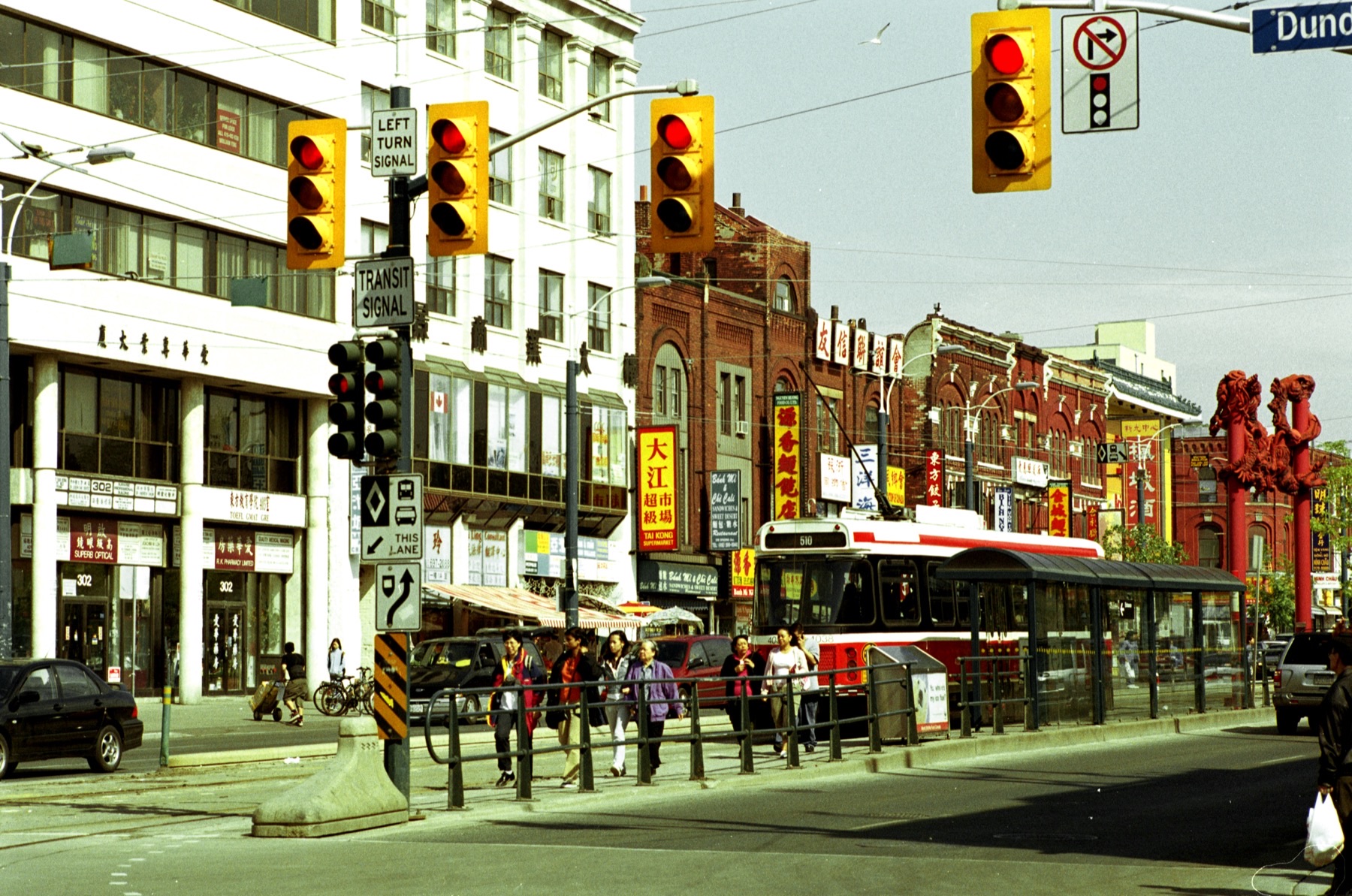 Spadina Avenue streetscape in Toronto Chinatown with storefronts and traffic.