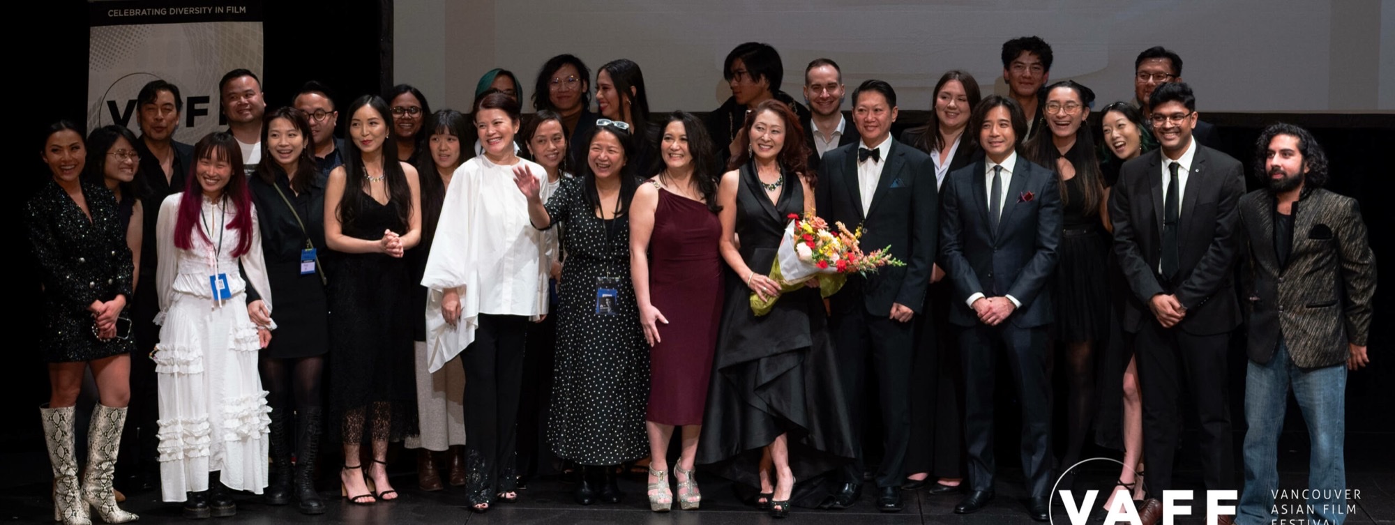 Cast and guests on stage at a Vancouver Asian Film Festival night, with VAFF branding visible in the frame.