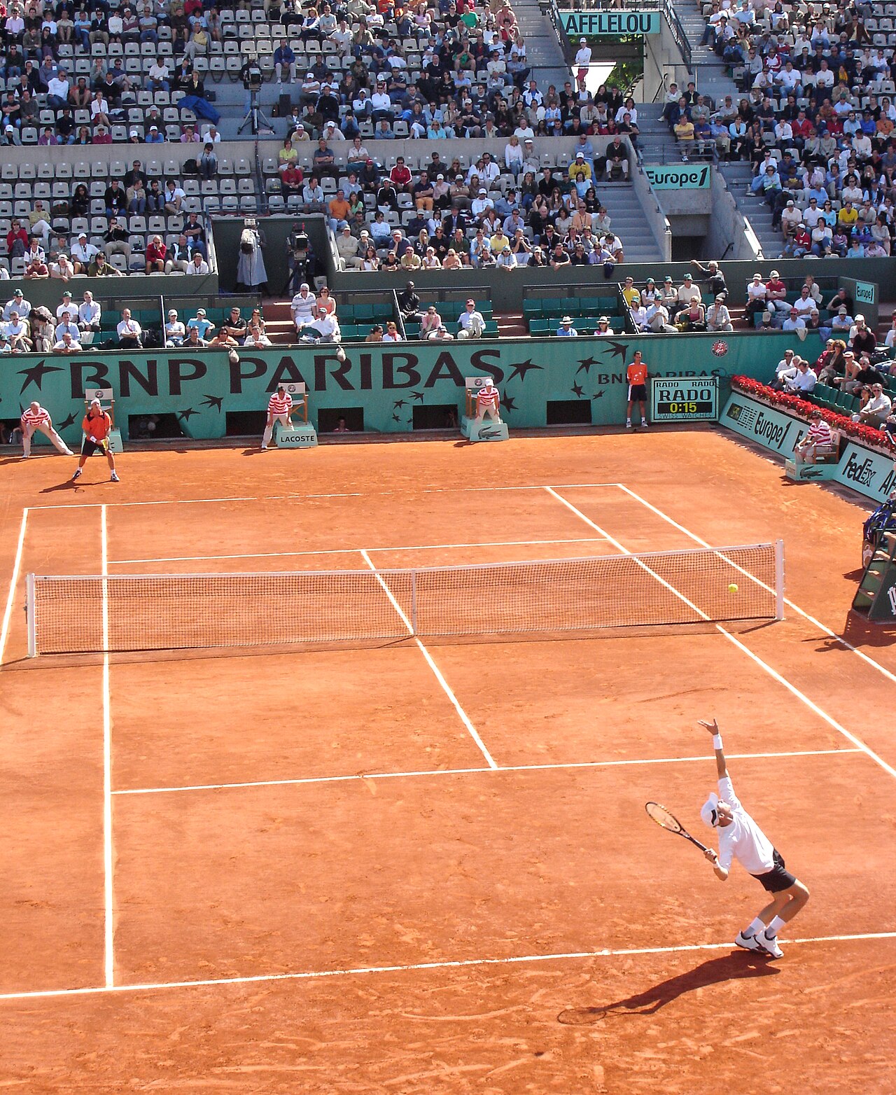 Context image: clay court tennis stadium.